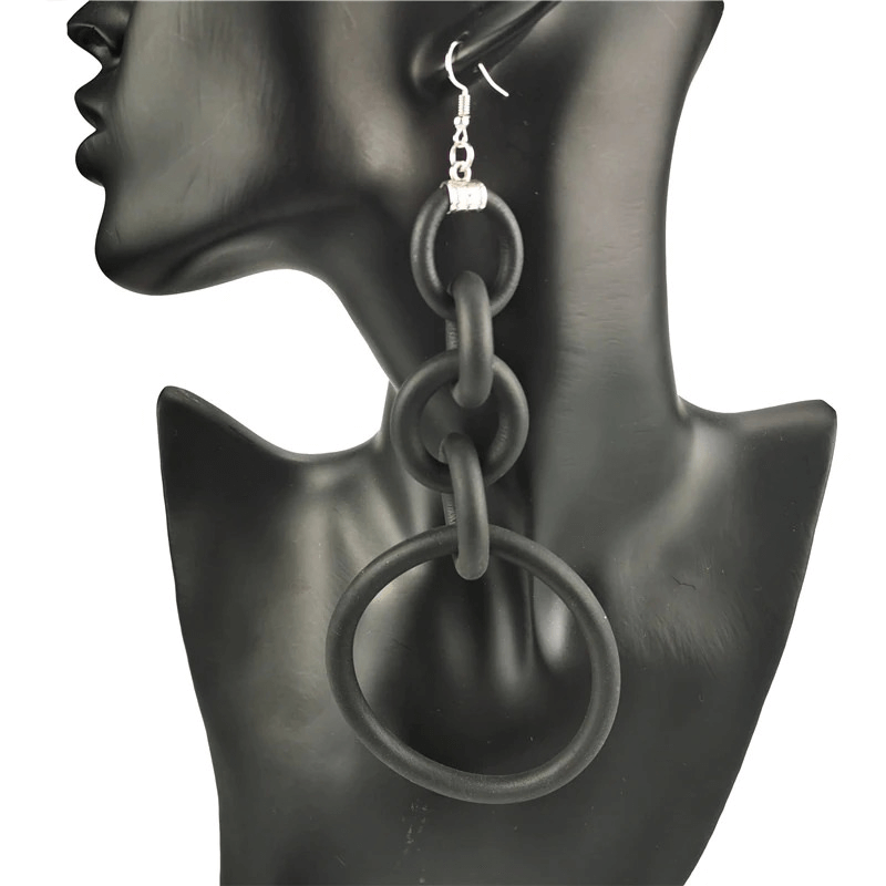 Elegant black silicone big drop earrings showcased on a mannequin bust, perfect for casual outfits.