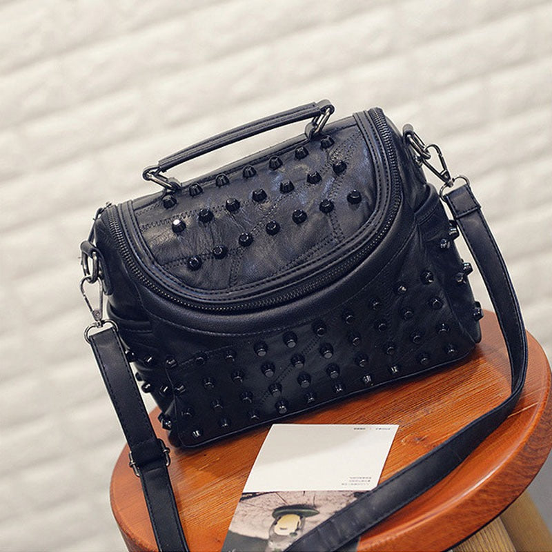 Luxury black women's sheepskin messenger bag with rivets, perfect for daily use and stylish night outs.
