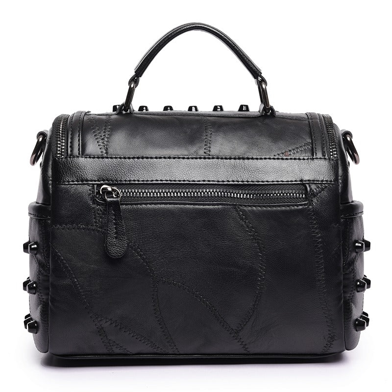Luxury black women's sheepskin messenger bag with rivet accents, perfect for any occasion.