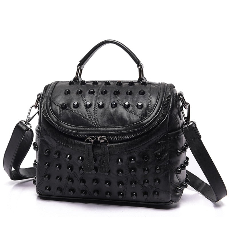 Luxury black women's sheepskin messenger bag with rivets, perfect for stylish outings and daily essentials.