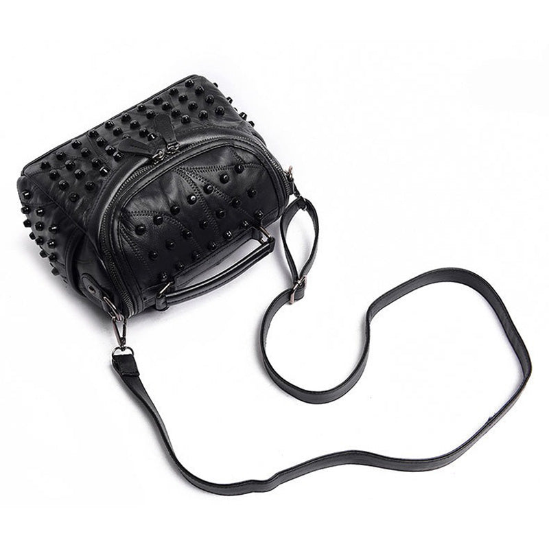 Luxury black women's sheepskin messenger bag with rivets, perfect for daily use or nights out.