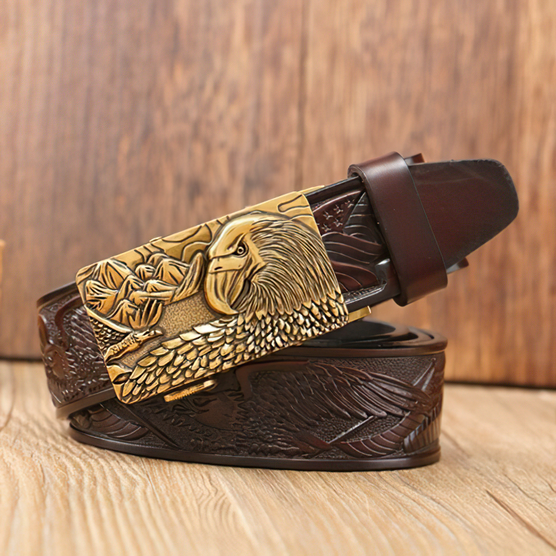 Luxury genuine leather belt for men featuring detailed eagle print and stylish buckle on wooden background.