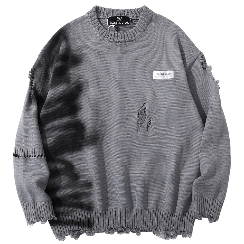 Oversized grey graffiti sweater with distressed detailing and vintage style, perfect for a trendy wardrobe refresh.