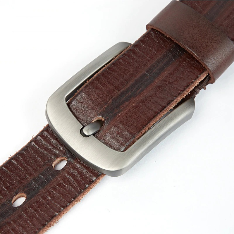 Close-up of a luxury brown leather men's belt with a stylish silver buckle, perfect for casual wear with jeans.