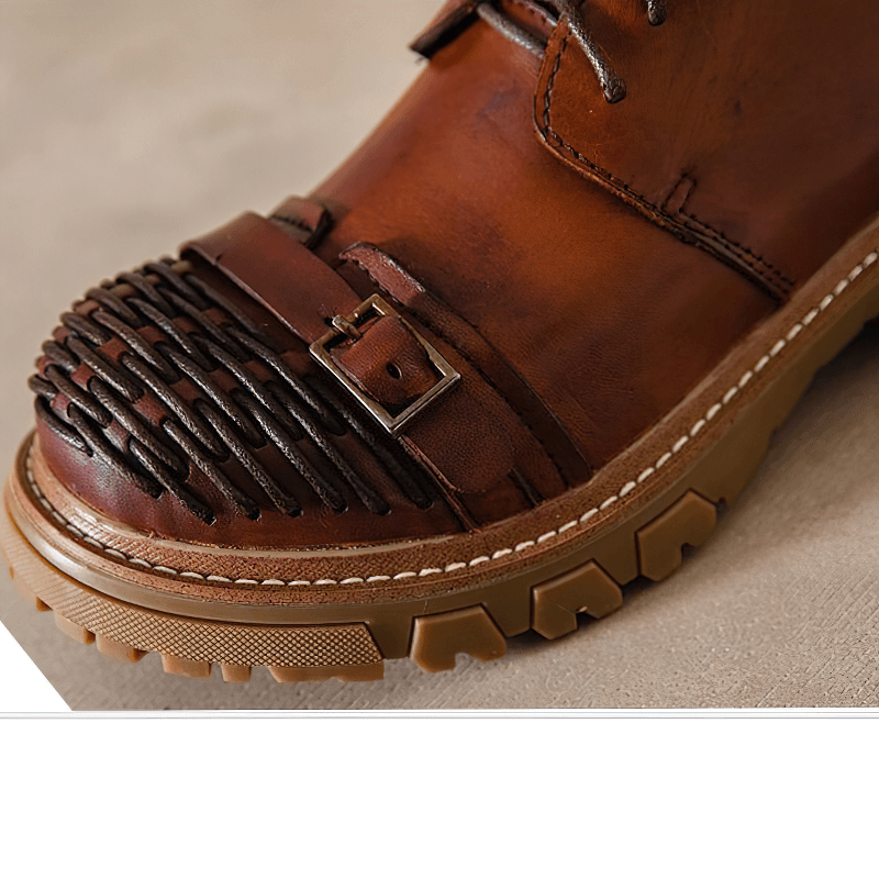 Close-up of luxury men's genuine leather work boot with stylish woven toe detail and durable platform sole.