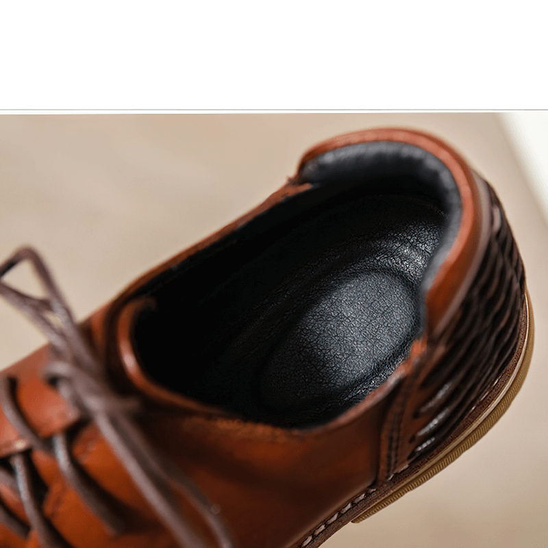 Interior view of luxury men's genuine leather boots showcasing a comfortable, padded insole for all-day wear.