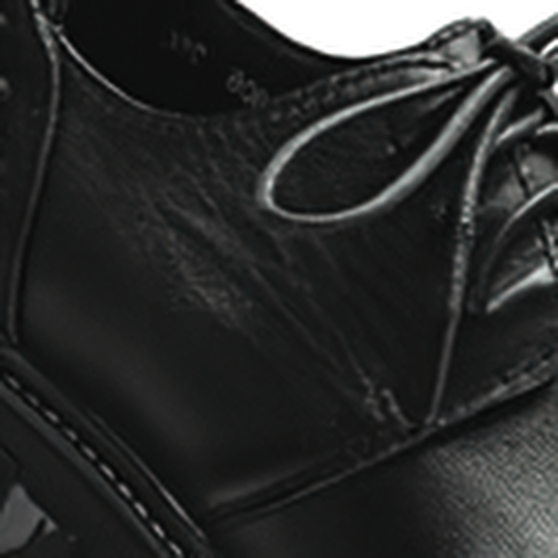 Close-up of luxury men's genuine leather work boots showcasing the sleek black design and casual lace-up style.