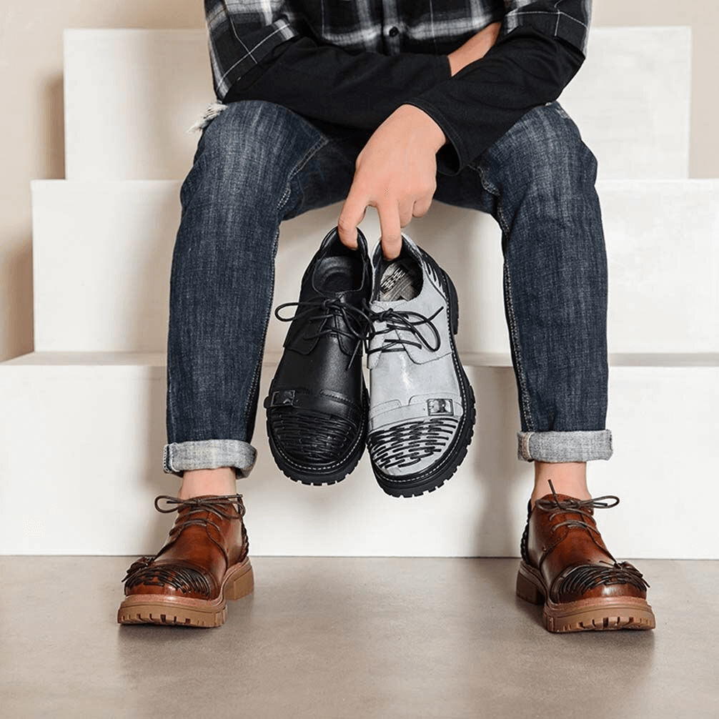 Man holding black and brown luxury leather casual shoes, showcasing stylish options for versatile outfits.