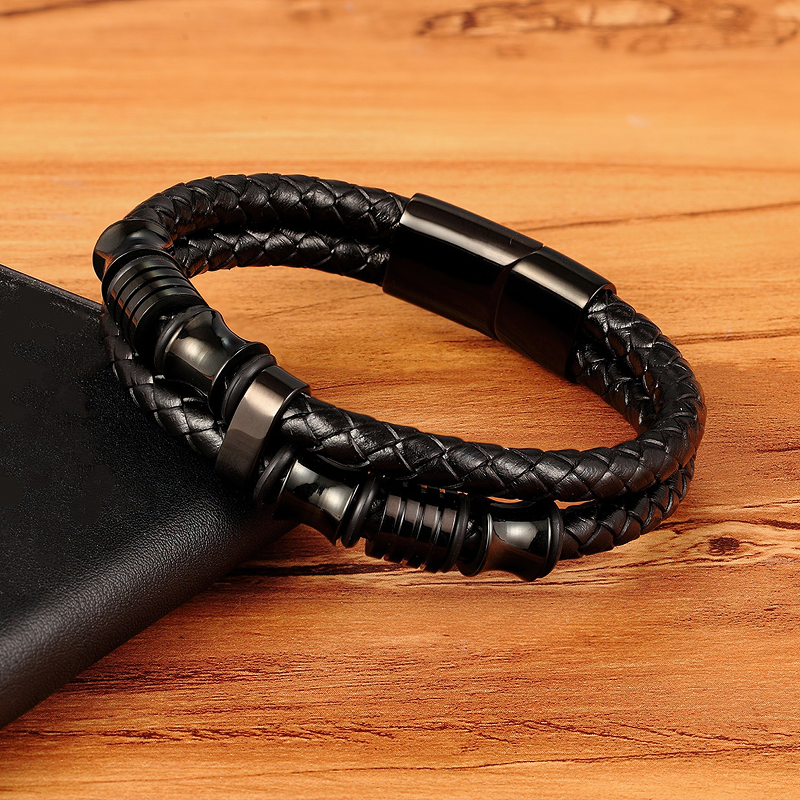Luxury men's bracelet made of genuine leather and stainless steel, featuring a trendy rope chain design on wood background.