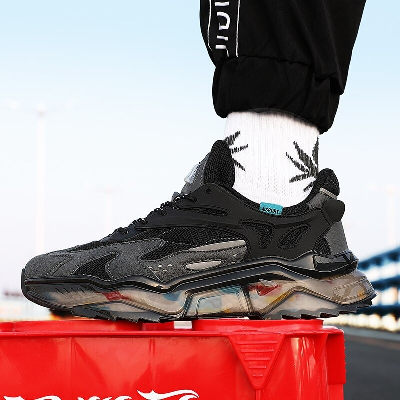 Black luxury mesh breathable running sneakers on a red crate, showcasing stylish design and casual wear.