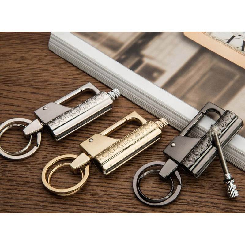 Three stylish keychain lighters in silver, gold, and black on a wooden surface, showcasing their multifunctional design.