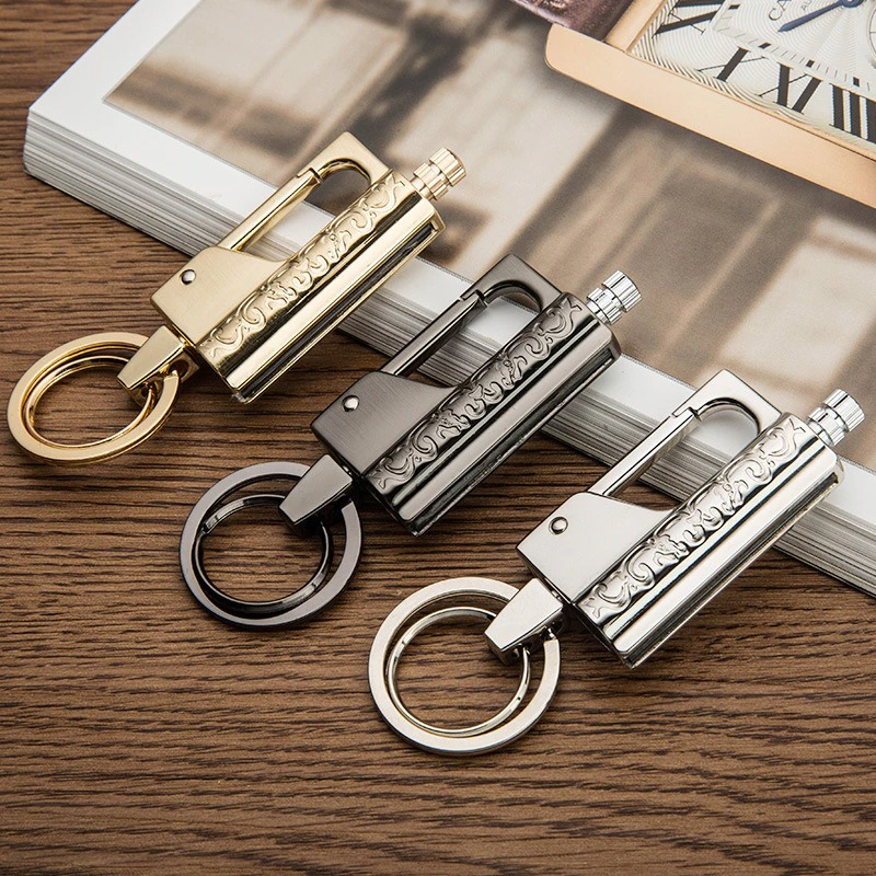 Luxury multifunction keychain lighters in gold, black, and silver on a wooden surface. Perfect casual accessory.