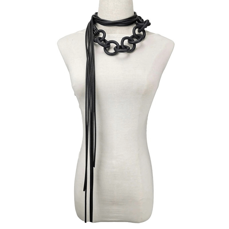 Handmade long black rubber necklace on a mannequin, showcasing unique gothic style and elegant design for women.