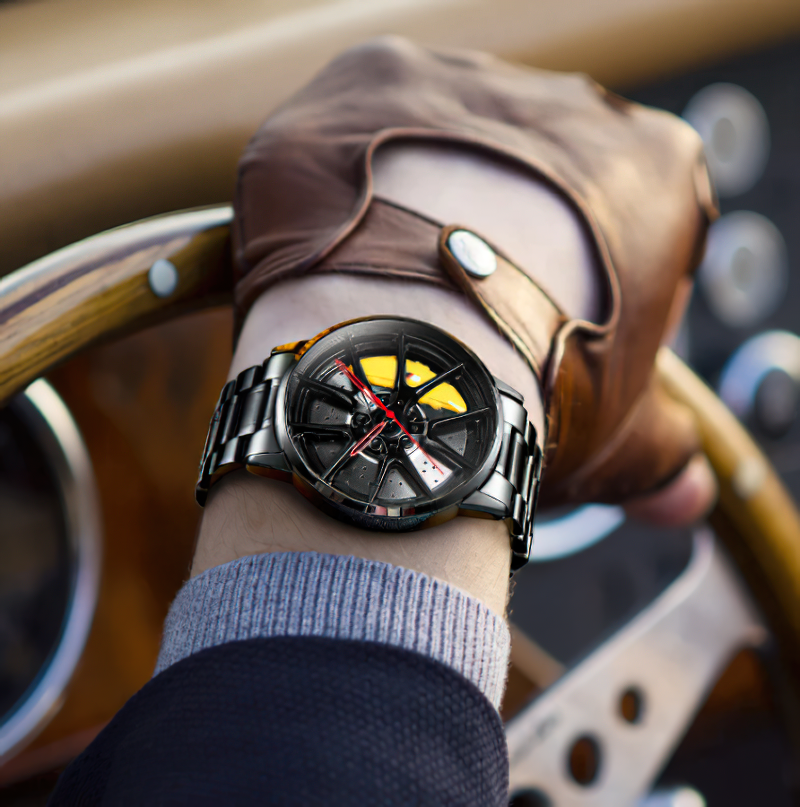 Stylish men's waterproof watch with wheel design, showcased while gripping a vintage car steering wheel.