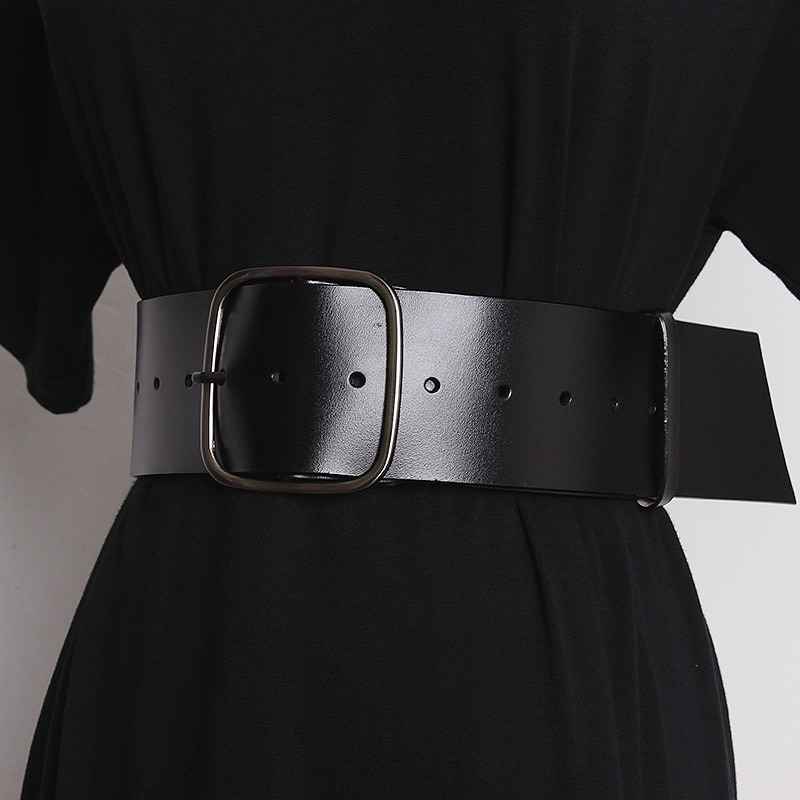 Luxury wide black leather belt for women with a metal buckle, perfect for stylish outfits.