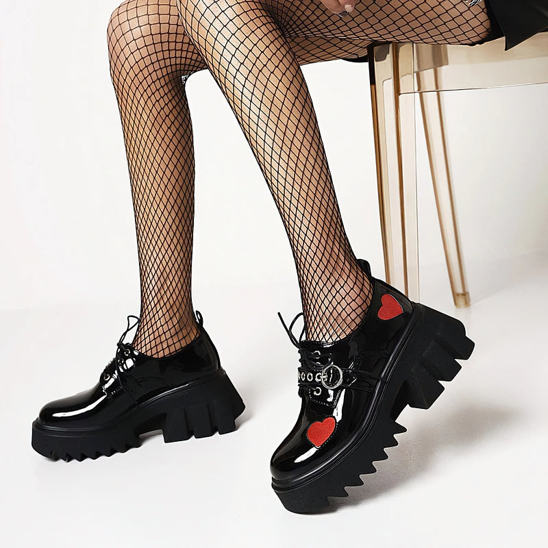 Luxury women's chunky black pumps with heart details, perfect for punk and goth fashion. Stylish and edgy footwear for trendy looks.