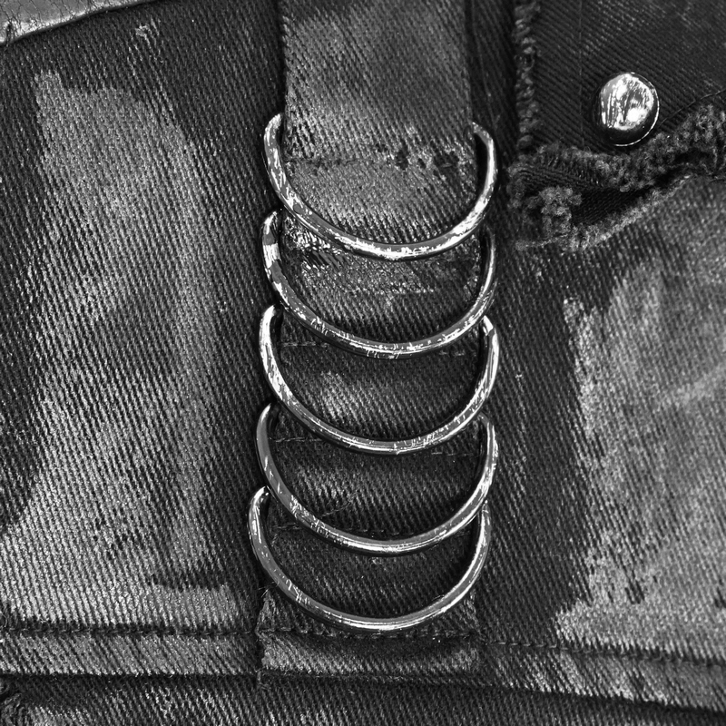Close-up of silver rivets on a black steampunk vest, highlighting stylish design details.