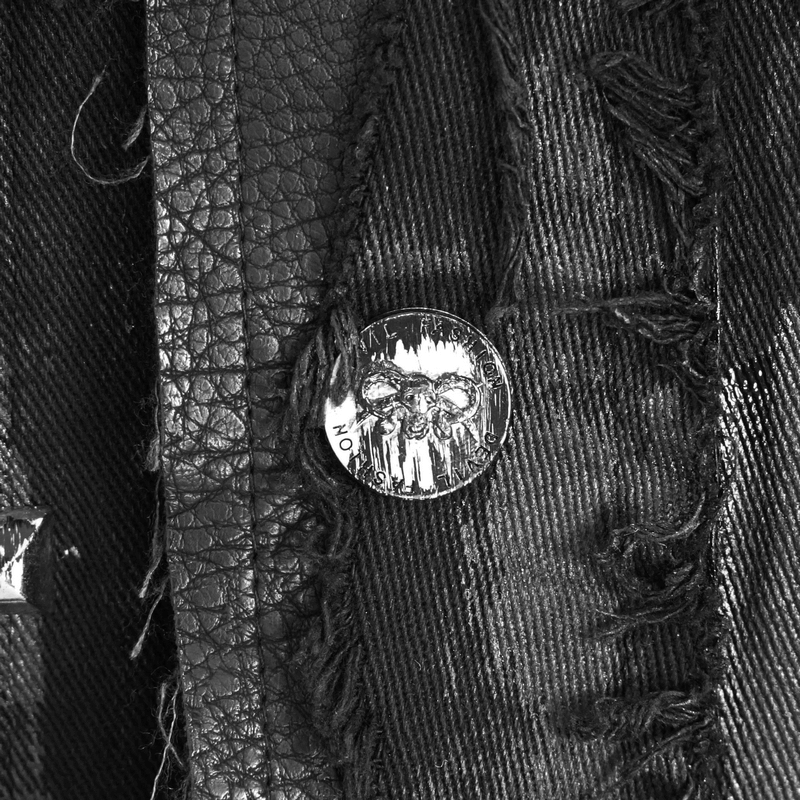 Close-up of a silver rivet on a black steampunk waistcoat featuring a skull design.