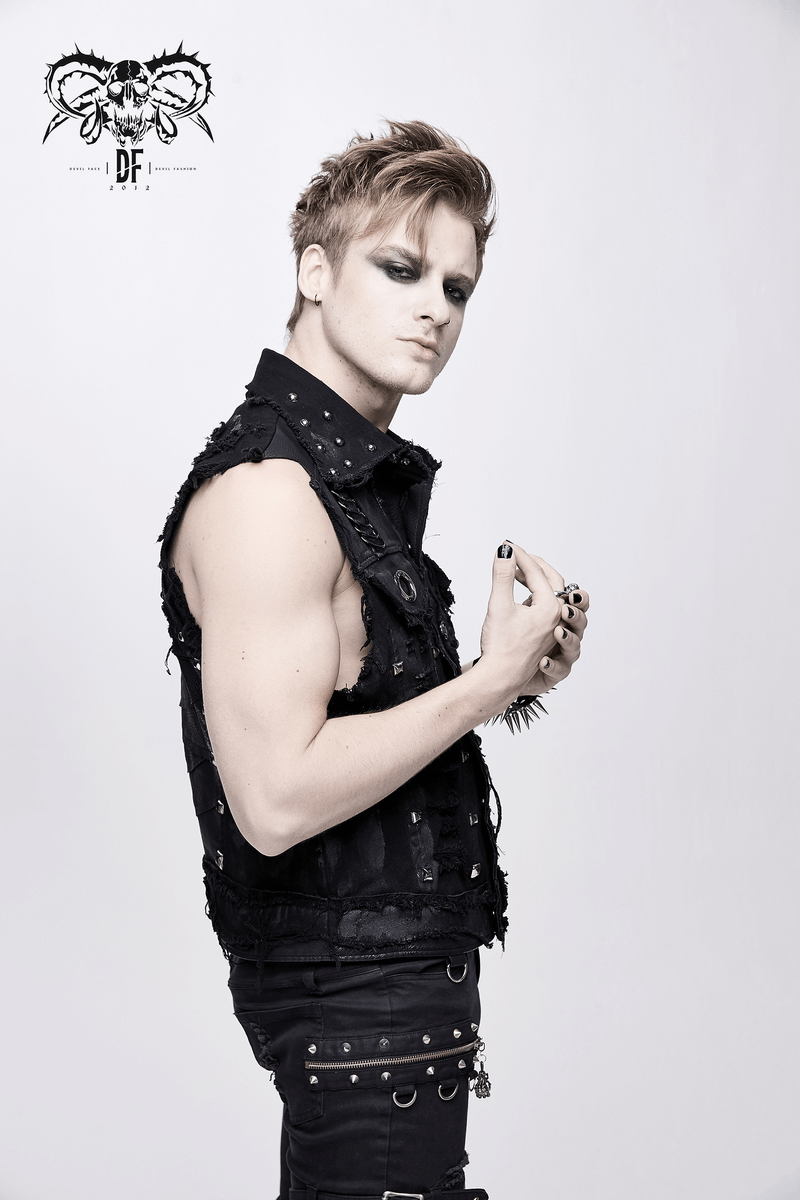 Stylish male model in a black vest with rivets, showcasing modern steampunk fashion.
