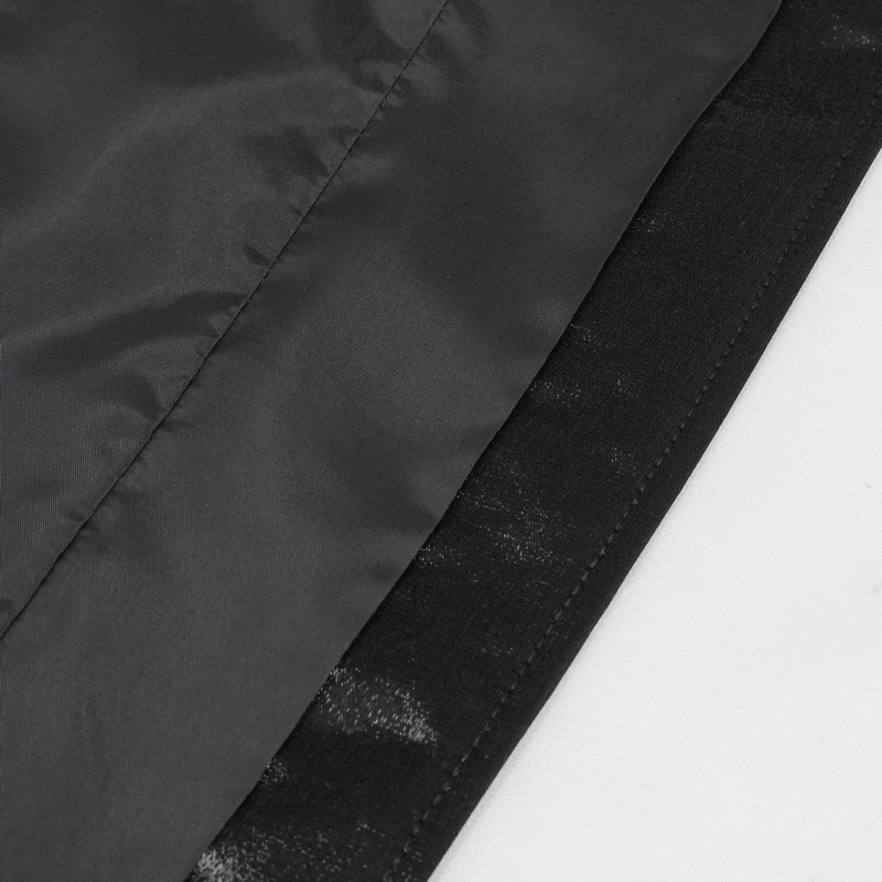 Close-up of black fabric layers showcasing the elegant material of a men's gothic waistcoat.