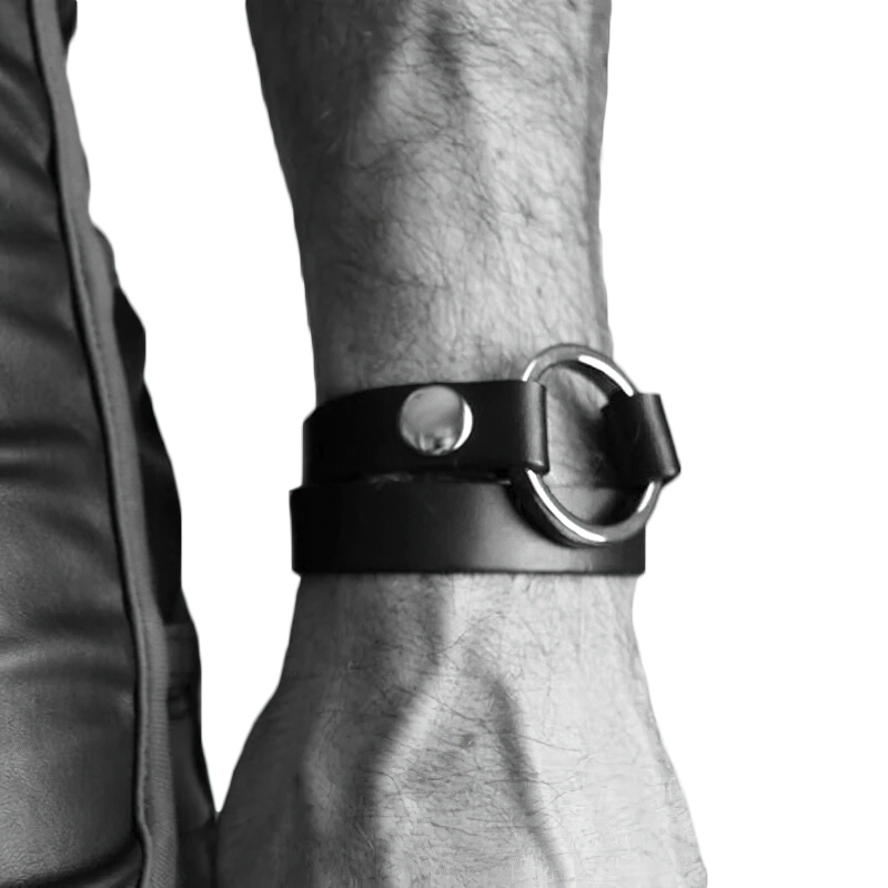Black PU leather wrist cuff with a silver ring, perfect for punk body harness bondage and stylish fetish accessories.