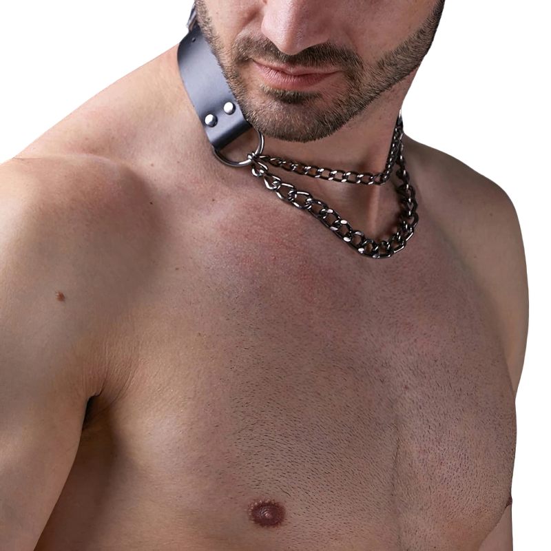Close-up of a man wearing a punk-style body harness with a metal chain, showcasing edgy bondage fashion.