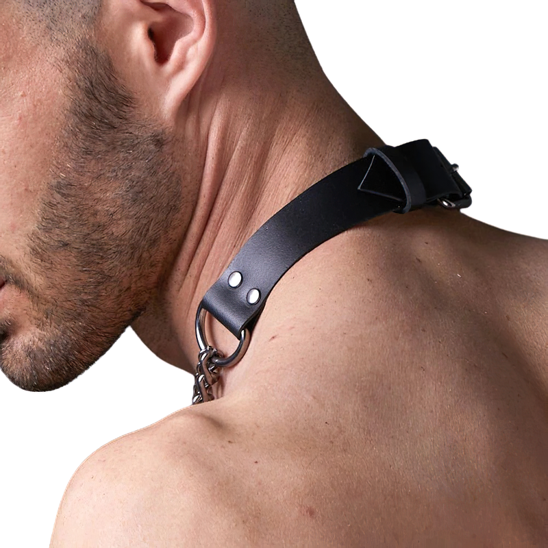 Close-up of a male body harness with black PU leather and metal chain, showcasing a punk-inspired design.