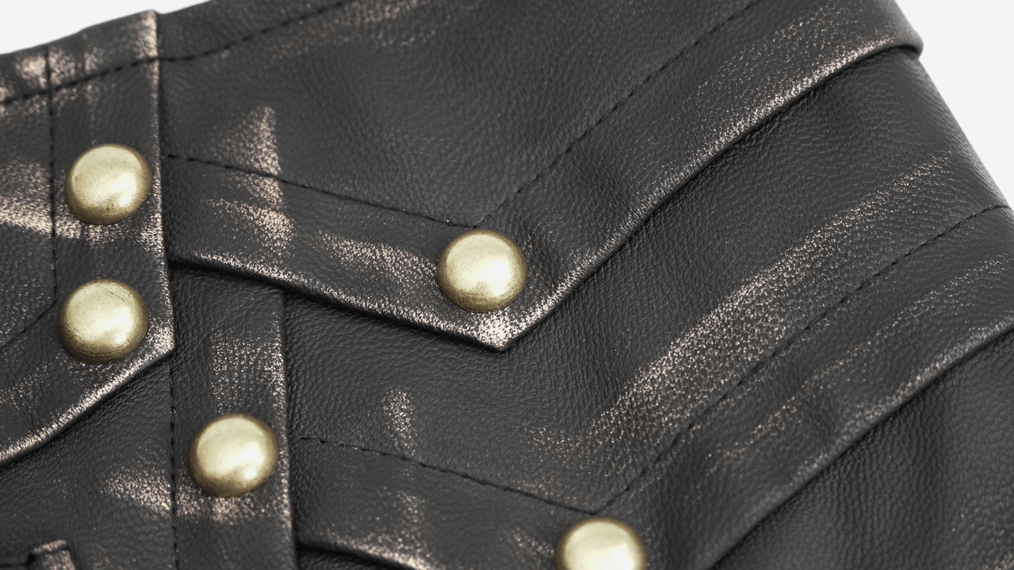 Close-up of a stylish black PU leather fabric with shiny gold studs for a vintage goth belt.