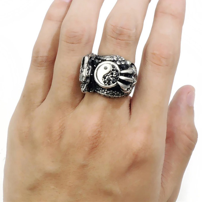 Stylish male dragon claw stainless steel ring on hand, perfect for alternative fashion and biker jewelry.