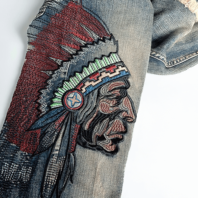 Close-up of detailed embroidery of a Native American chief on trendy denim jeans for men.