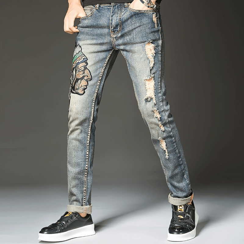 Stylish men's ripped denim jeans with embroidery, perfect for alternative fashion and casual comfort.
