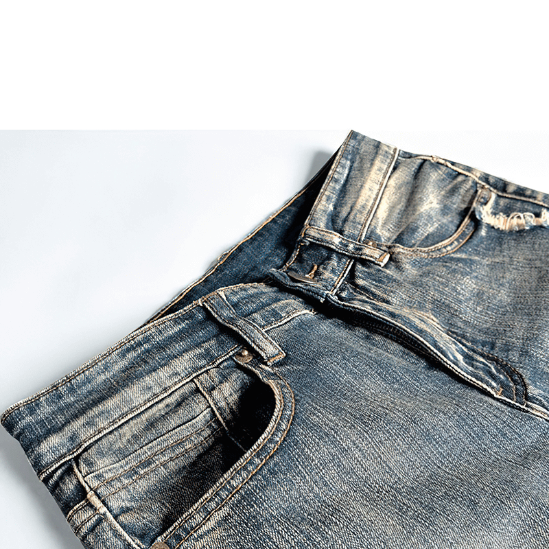 Close-up of stylish male embroidery denim jeans with a trendy ripped design and alternative style.