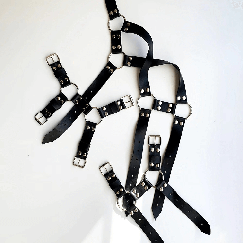 Men's adjustable body harness made of PU leather with silver fittings for a punk BDSM style.