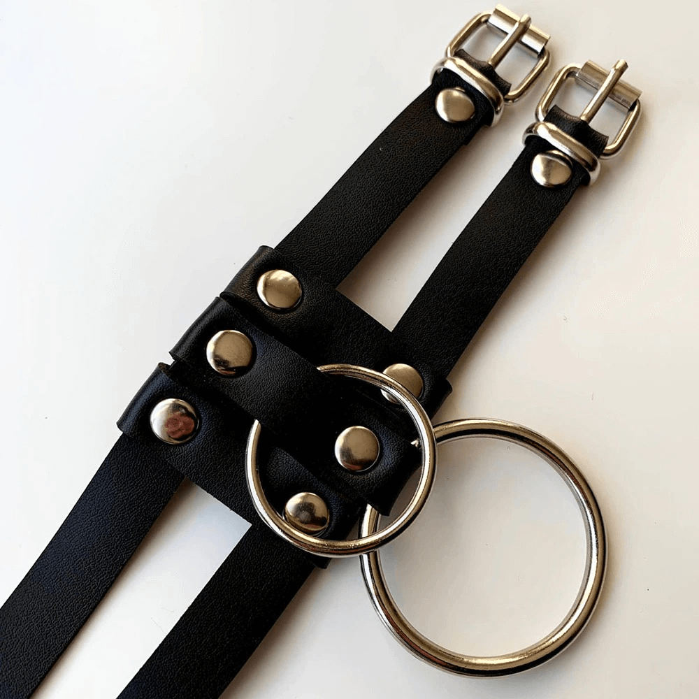 Stylish black PU leather body harness with silver rings and buckles, perfect for punk and BDSM fashion.