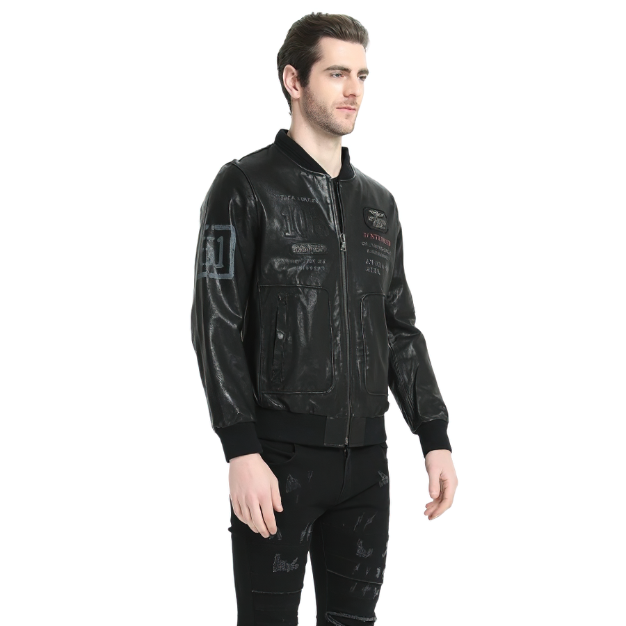 Stylish male model wearing a black genuine leather biker jacket with detailed print, showcasing modern fashion.