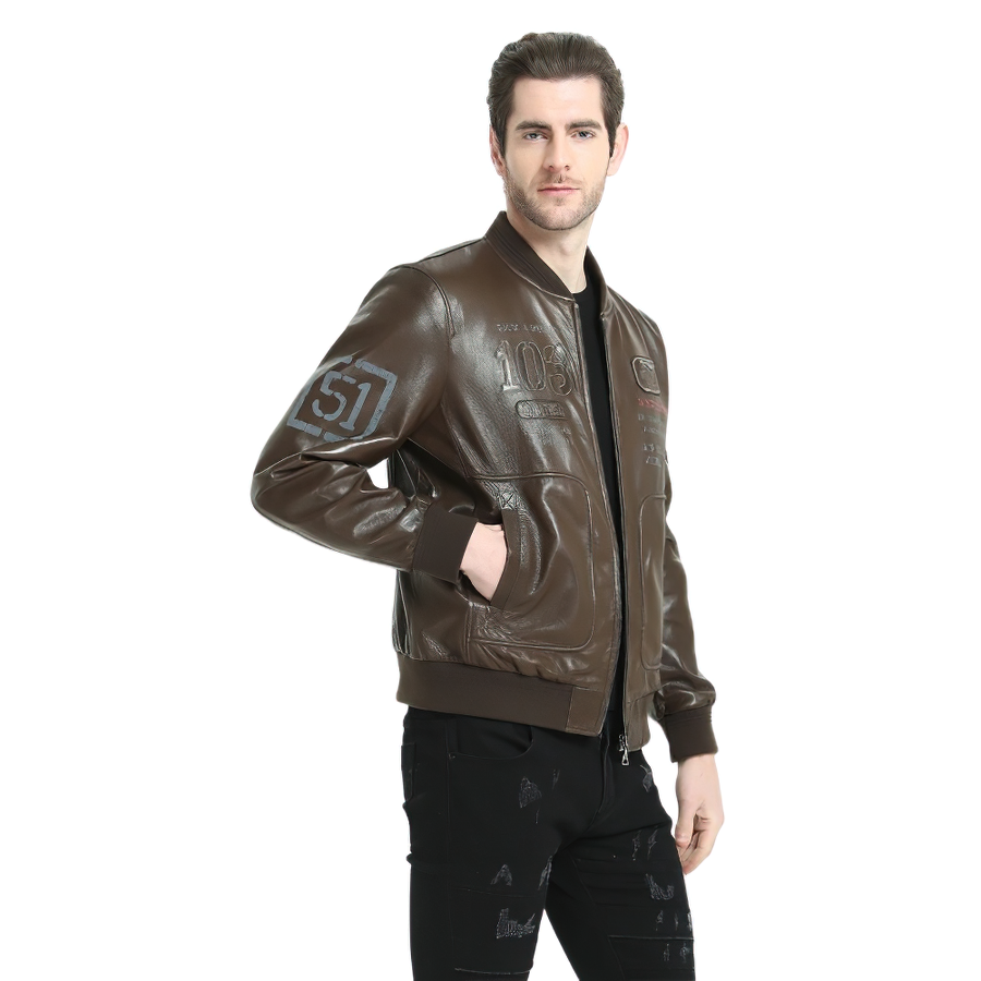 Stylish male model wearing a brown genuine leather bomber jacket with printed details and zippered closure.