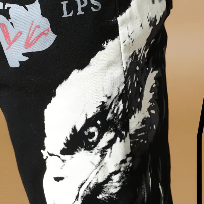 Close-up of male graffiti print black denim pants showcasing unique design and quality fabric.