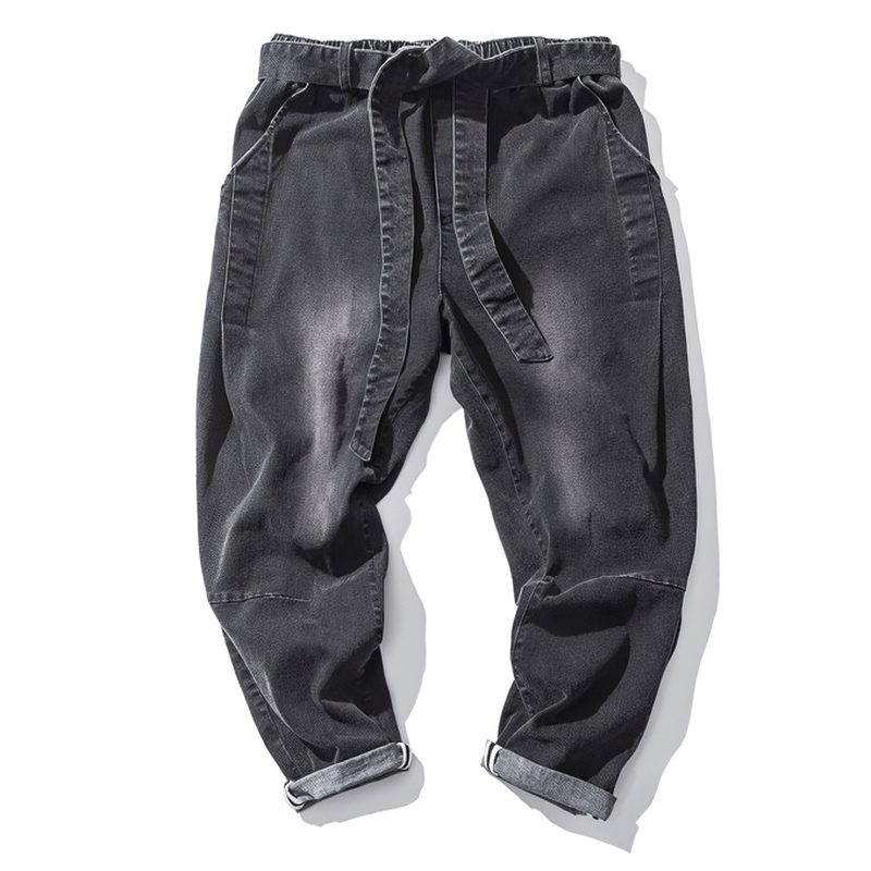Men's loose denim pants with belt in dark color, perfect for casual stylish outfits.