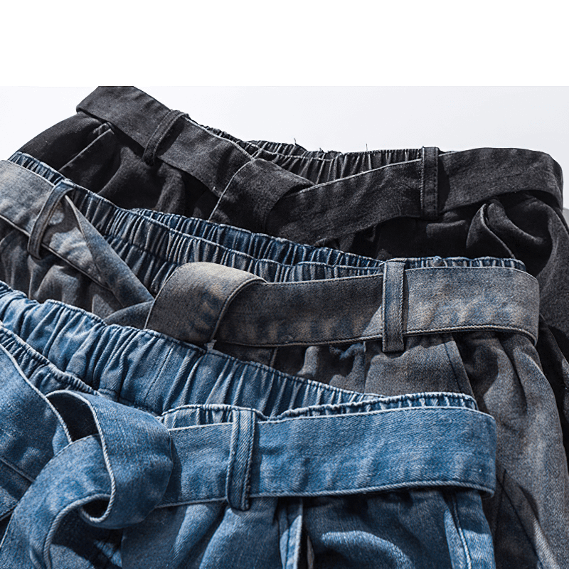 Close-up of loose denim pants in various colors with stylish belts, perfect for casual outfits.