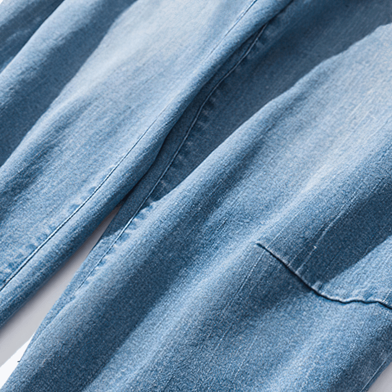 Close-up of loose denim pants fabric showing texture and shade, ideal for casual style.