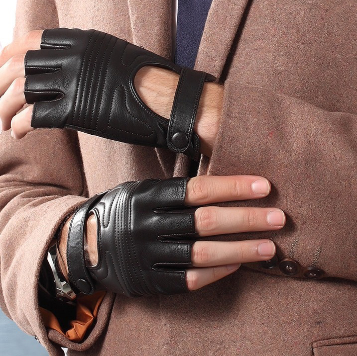 Stylish male wearing black leather fingerless gloves in punk style, complementing a chic outfit.
