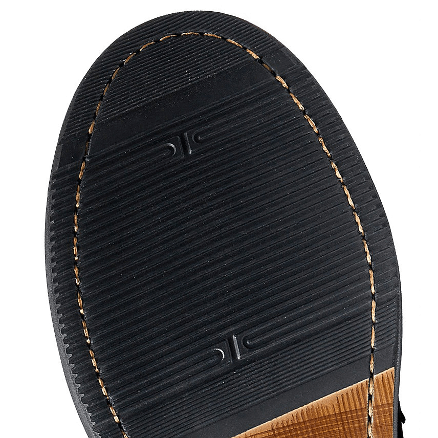 Close-up view of the sole of a men's soft leather Oxford shoe with textured pattern for grip and style.