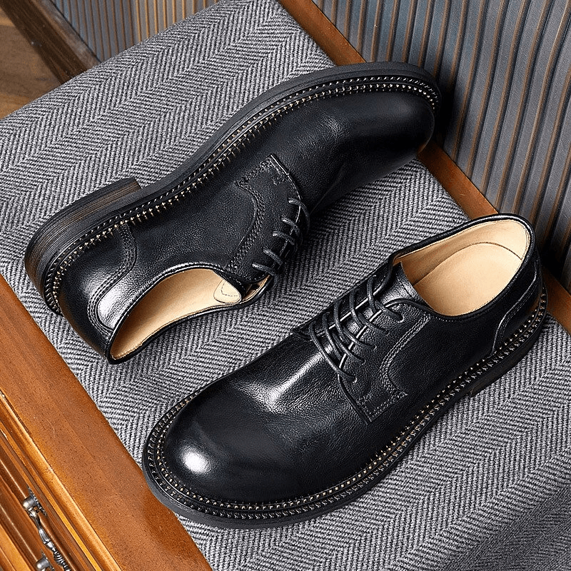 Elegant black leather oxford shoes with lace-up design, showcasing retro style on a stylish surface.