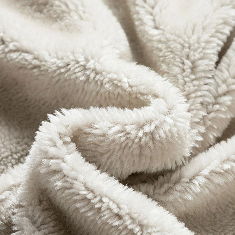 Cozy close-up of soft beige plush fabric, perfect for warm blankets or winter garments.