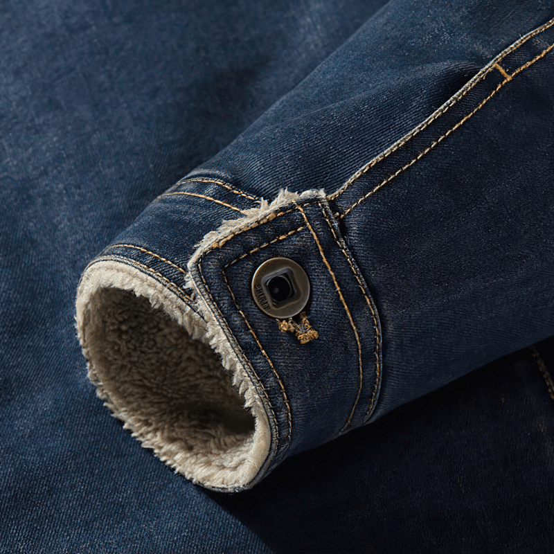 Close-up of a men's warm denim jacket sleeve with button detail and cozy lining, showcasing its stylish design.