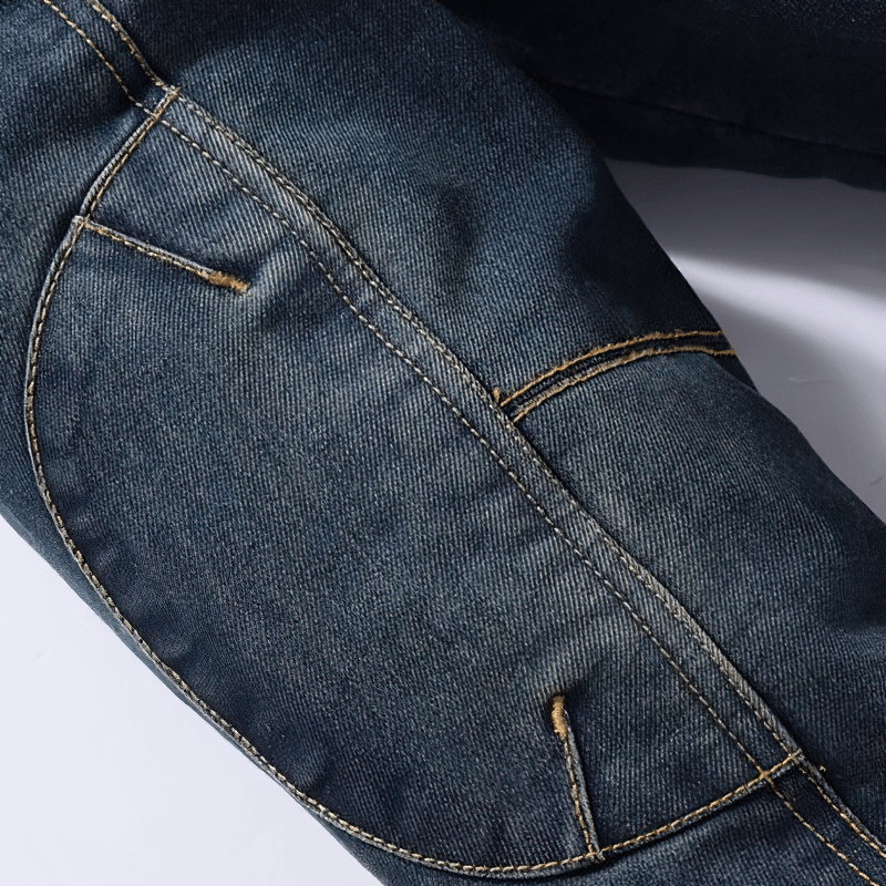 Close-up of the detailed stitching on a men's loose denim jacket, showcasing multi-pocket design and stylish fabric.