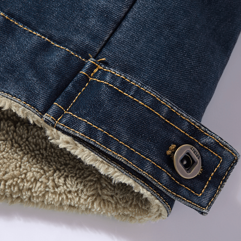 Close-up of male denim jacket cuff with button and cozy lining, showcasing casual style and multi-pocket design.