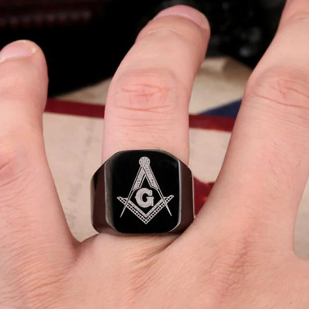 Unisex stainless steel Masonic ring on a hand, featuring a geometric design with the letter G, perfect for punk-style jewelry.