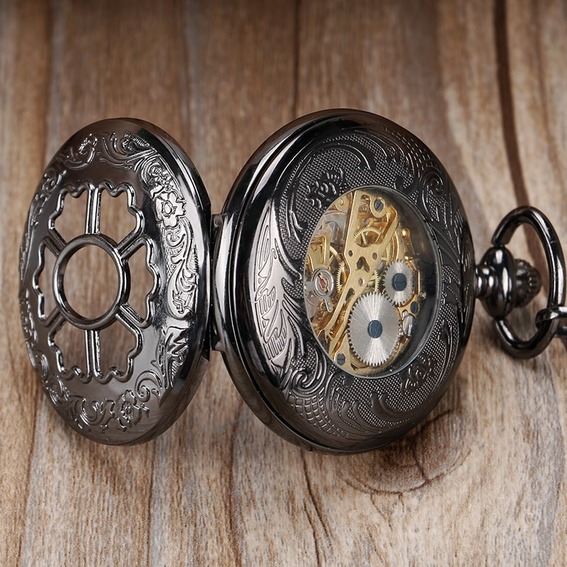 Luxury vintage mechanical pocket watch with intricate flower design and visible gears.