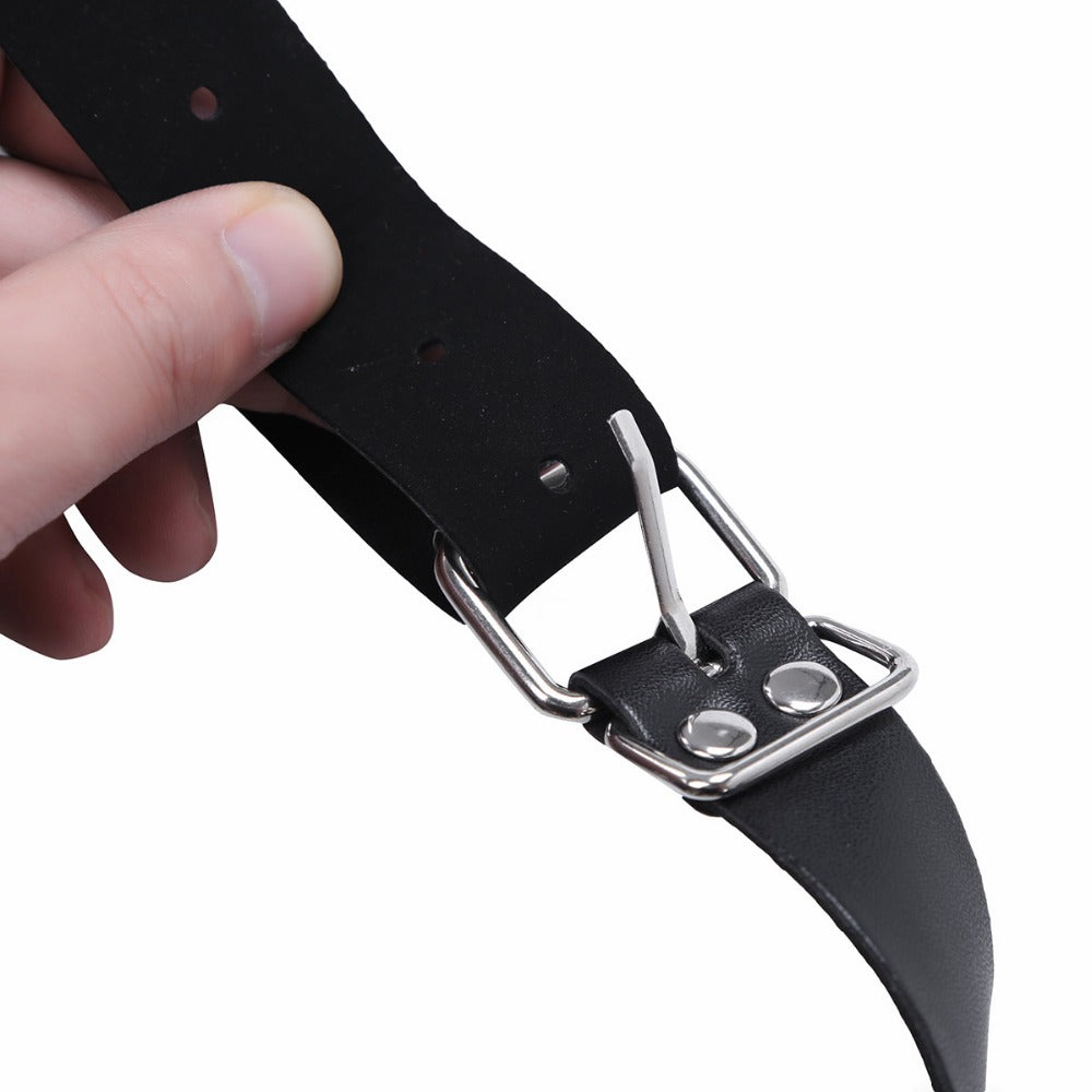 Close-up of a hand holding a black PU leather strap with a metal buckle, ideal for medieval costume armor.